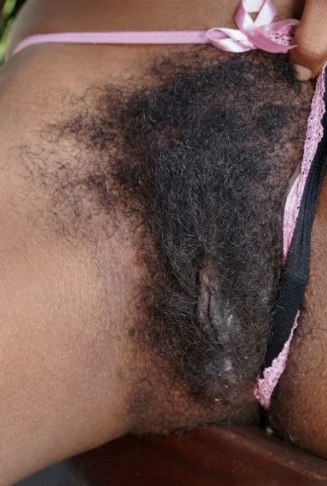 Showing hairy curly pussy close-up